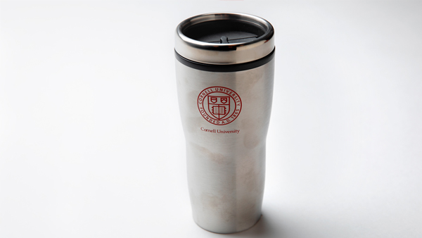 Silver travel mug with Cornell insignia