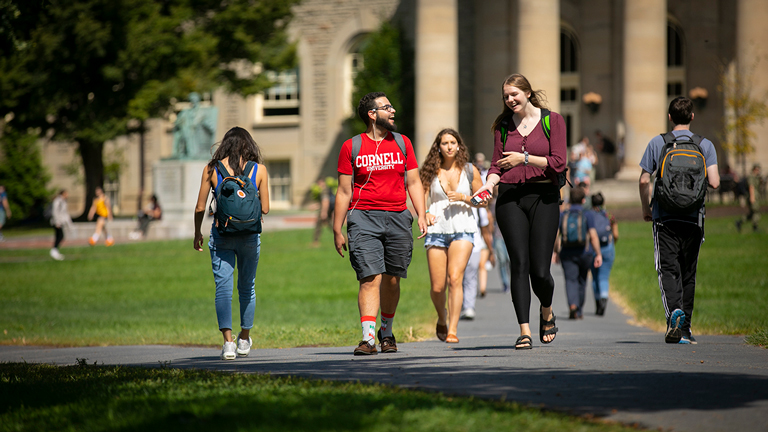Students talk as they walk across campus