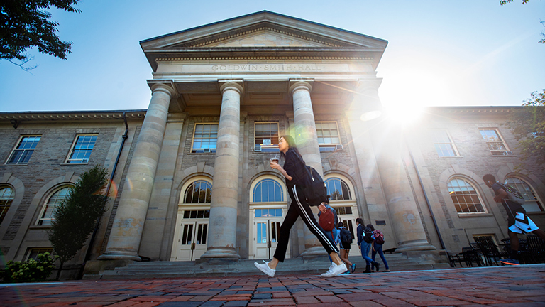 Morning light peeks over Goldwin Smith Hall as students head to class.
